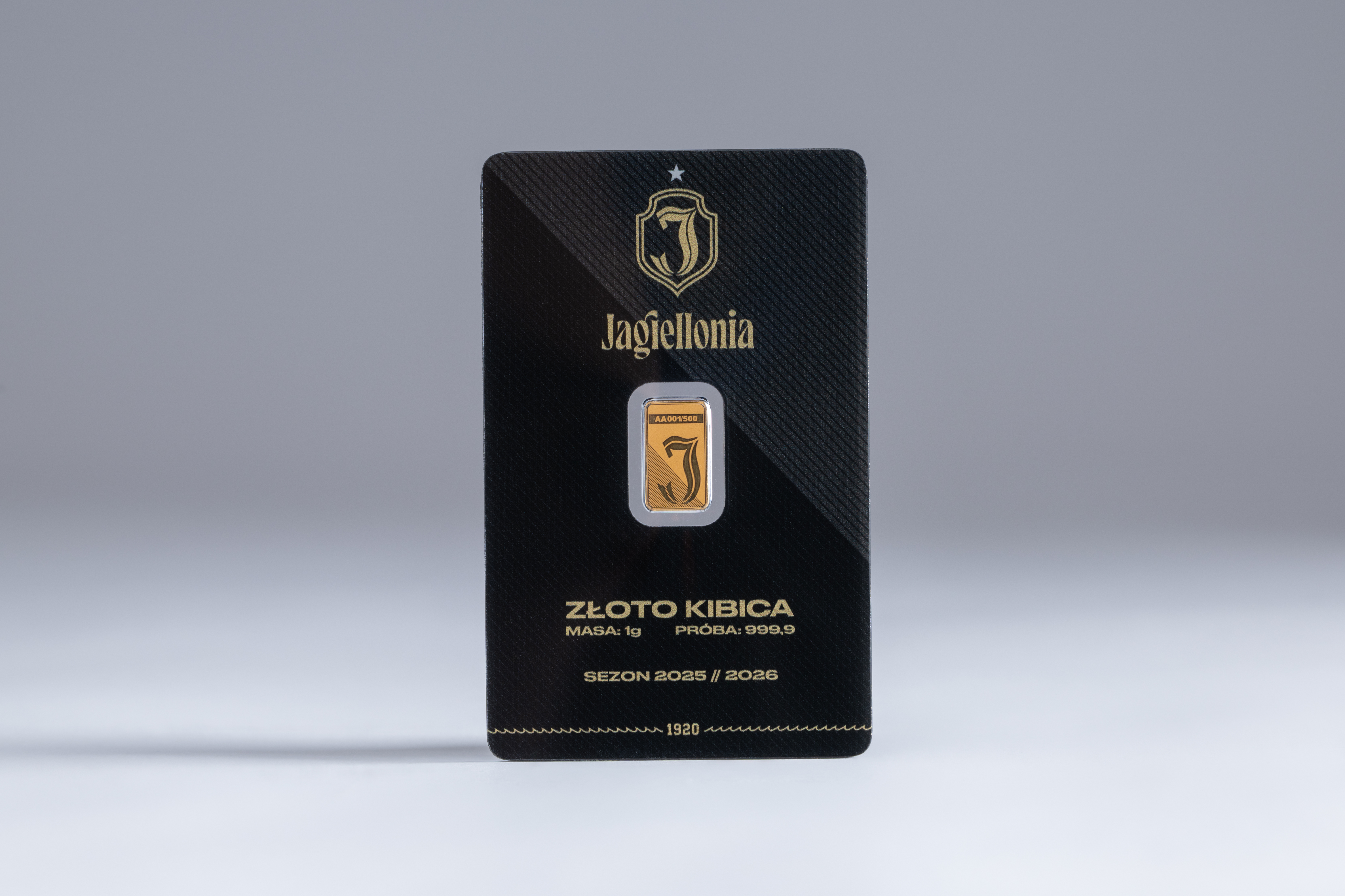 gold bar 1 gram Jagiellonia Białystok front view, detailed emblem, Au 999.9, red and yellow colors, professional studio photography with dramatic lighting